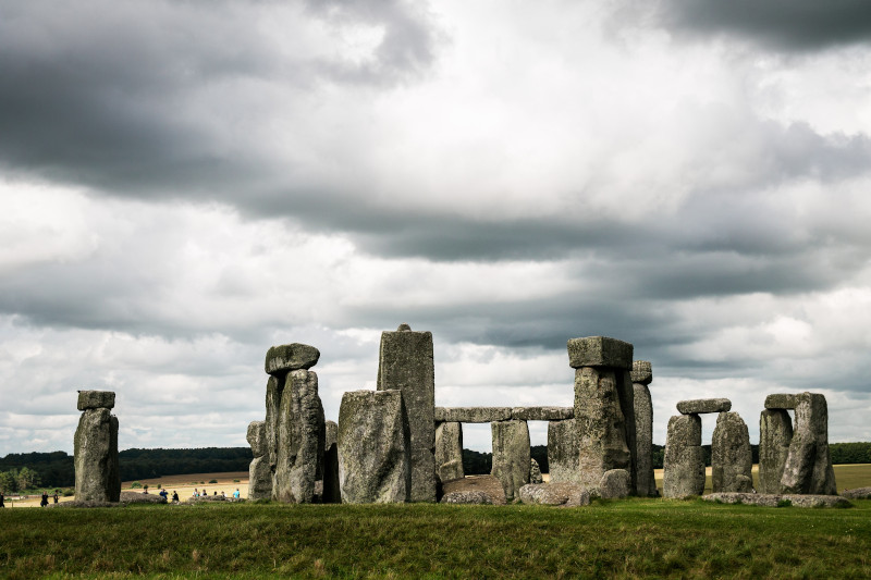 the first rays of sunrise shine right into the heart of Stonehenge at Summer Solstice