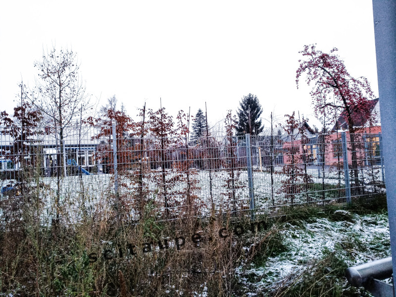 Snow covers a park and play area - Winter in Germany